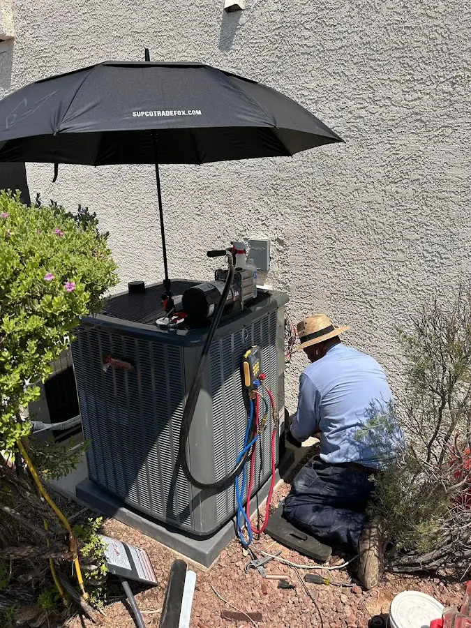 HVAC technician performing outdoor AC maintenance in Cypress Gardens