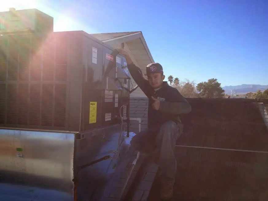 HVAC technician performing Heat Pump Repair on a rooftop unit in Cypress Gardens